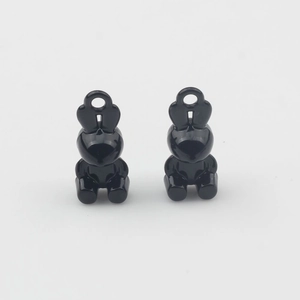 Detailed view of two polished black alloy 3D rabbit charms for DIY jewelry making