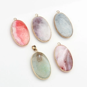 Detailed view of five oval natural agate stone pendants with elegant gold plated metal edges