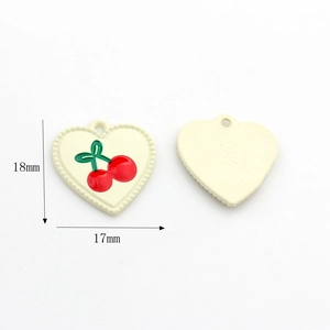 Detail view showing 18x17mm cream heart charm with cherry pattern for DIY jewelry