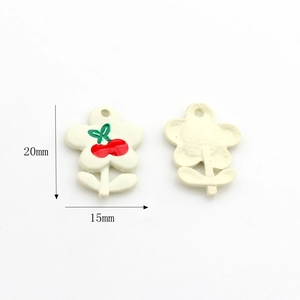 Detailed macro view of cream flower charm with cherry pattern for DIY jewelry