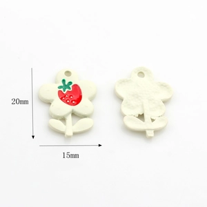 Detail of flower-shaped alloy pendants with strawberry pattern for DIY jewelry making