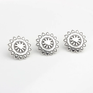 Set of three vintage silver alloy sunburst buttons with heart motifs and petal details