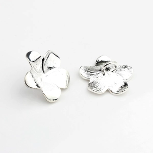 Detail of silver alloy frangipani flower button with textured petals and back loop