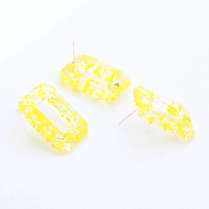 Detail of rectangular resin earring components with yellow splatter and silver pins