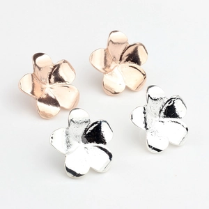 Close-up of alloy frangipani flower charms in silver and rose gold for DIY jewelry