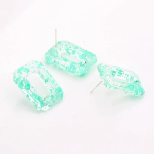 Detailed macro view of S925 silver needles on floral resin geometric earrings