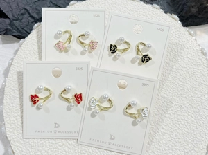 Flat lay of retro rose flower earrings with pearls on S925 cards in four colors