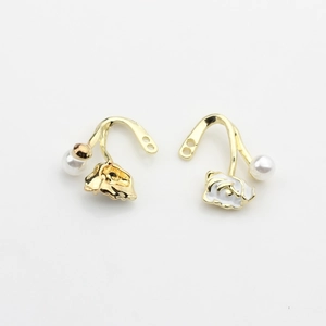 Detailed view of floral earring charms with white enamel petals and faux pearl accents
