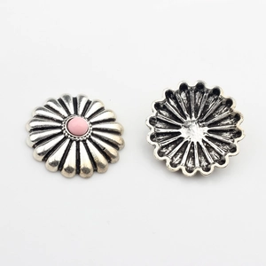 Detail of silver daisy concho metal button with pink resin center for DIY crafts