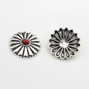 Close-up of vintage silver flower concho with red gemstone and detailed hollow back view