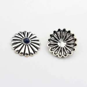 Macro shot of retro silver daisy buttons with dark blue resin gemstones for DIY crafts