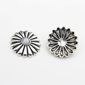 Macro view of retro silver daisy concho buttons with white turquoise stone center