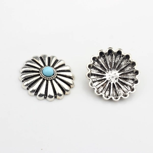 Detailed front and back view of vintage daisy metal charm with blue turquoise inlay