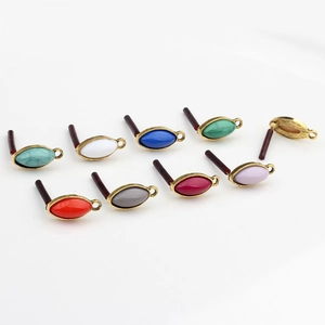 Detailed view of marquise resin pendants with gold alloy frames in nine vibrant colors