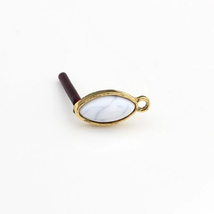 Macro view of gold vintage marquise resin stone pendant with hanging ring for DIY jewelry