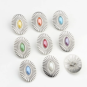 Macro detail of oval shank buttons with antique silver finish and colorful marquise stones