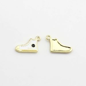 Detailed macro view showing both front and back of gold-plated enamel sneaker pendants