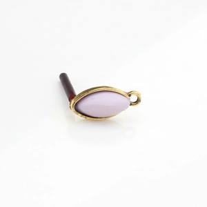 Close-up of vintage gold horse-eye resin component with a lilac finish for jewelry making