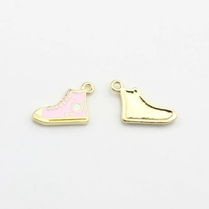 Detailed macro of pink enamel high-top shoe pendants with textured gold alloy back