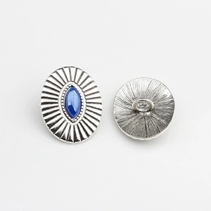 Detail of vintage zinc alloy button with antique silver finish and blue marquise stone