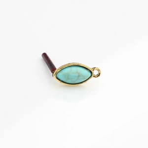 Detail of vintage gold alloy marquise resin turquoise stone ear stud jewelry component