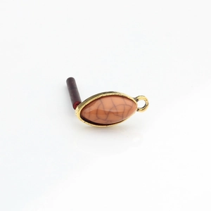 Detailed close-up of retro golden alloy marquise resin earring stud with amber texture