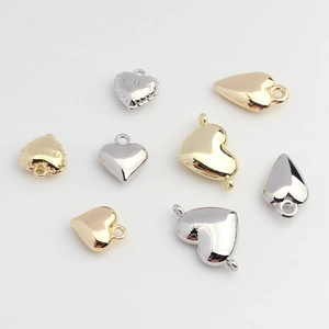 Polished gold and silver heart-shaped metal charms for DIY jewelry making with engraving
