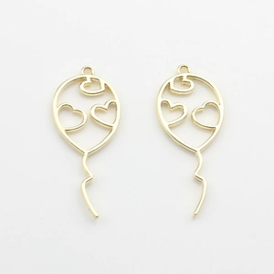 Detail of hollow heart balloon pendants in pale gold alloy for DIY jewelry making