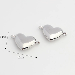 Detailed view of polished silver heart pendants with 12mm and 14mm size markings