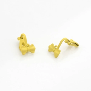 Detailed macro view of bright yellow matte painted bow earring clips for jewelry DIY