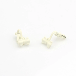 Detail of cream matte bow ear clip accessory made of alloy for non-pierced ears