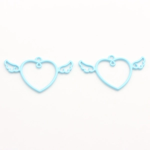 Close-up of light blue winged heart alloy charms for DIY jewelry and crafts making
