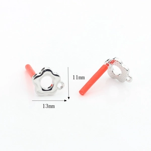 Macro view of 13mm flower alloy charm with pearl setting and red rubber sleeve