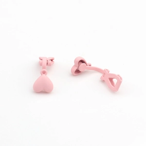 Detail of pink matte heart clip-on earrings for non-pierced ears with a sweet minimalist style