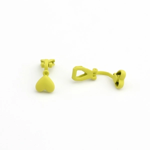 Detail view of heart-shaped clip-on earrings in a matte lime green painted finish