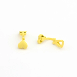 Detail of yellow heart-shaped clip-on earrings with matte enamel finish for non-pierced ears