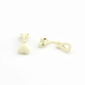 Close-up of heart-shaped cream matte alloy clip-on earrings for non-pierced ears