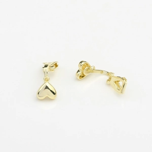 Detailed close-up of golden heart-shaped clip-on earrings with a polished glossy finish