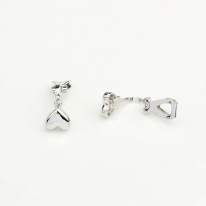 Detailed macro view of polished silver heart pendants with a sleek mirror finish