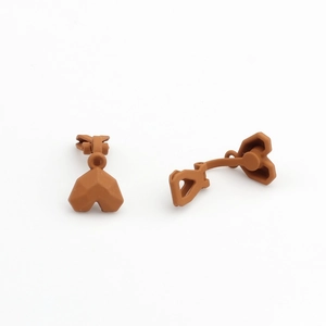 Macro detail of brown geometric heart-shaped matte resin ear clips for DIY jewelry