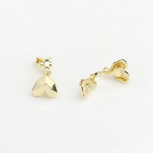 Macro shot of geometric faceted gold ear clip converters with polished mirror finish
