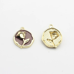 Detail of rose enamel charm showing gold-trimmed purple flower and matte metal back