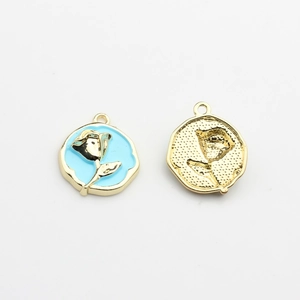 Detailed macro of gold alloy rose flower pendants with blue enamel for DIY earrings