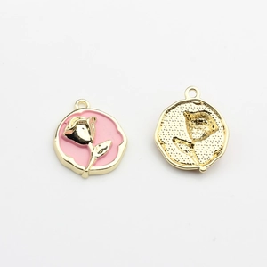 Detail of double-sided rose charm with pink enamel inlay and gold plated metal finish