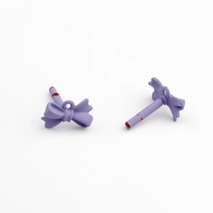 Detail of purple matte painted mini bow pendant with loop for DIY jewelry making