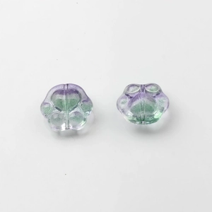 Detailed view of purple-green gradient glass cat paw beads for DIY jewelry making