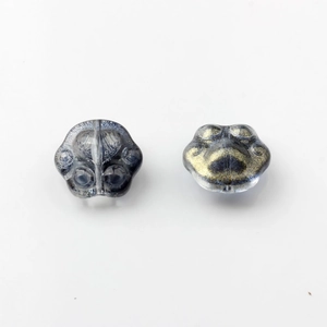 Macro detail of cat paw glass beads with sparkling gold and silver powder for DIY jewelry