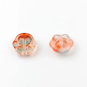 Detailed close-up of crystal glass cat paw charms with orange-pink gradient for DIY jewelry