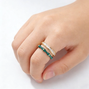 Bague double couche dorée avec émail vert motif bambou et oxydes de zirconium baguettes