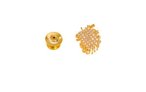 Close-up of a woven geometric gold brooch with sparkling zircons and a butterfly clutch